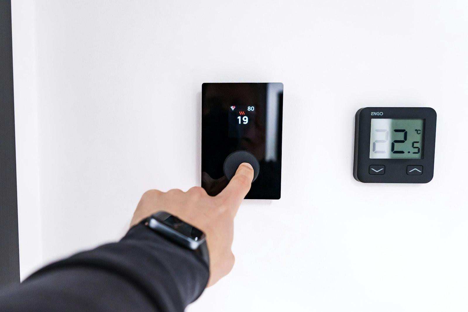 A hand using a smart home control panel