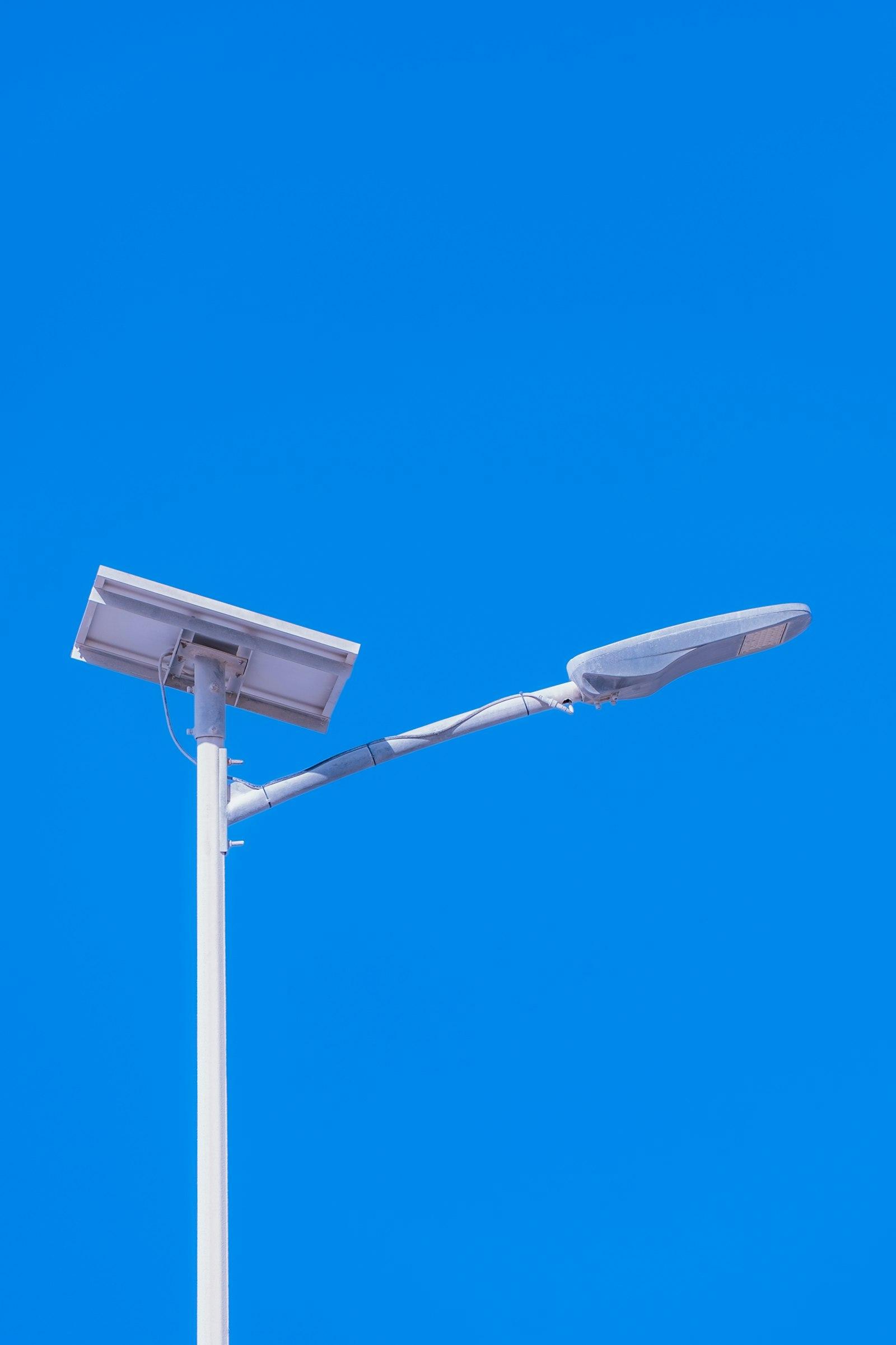 A solar street light against a blue sky