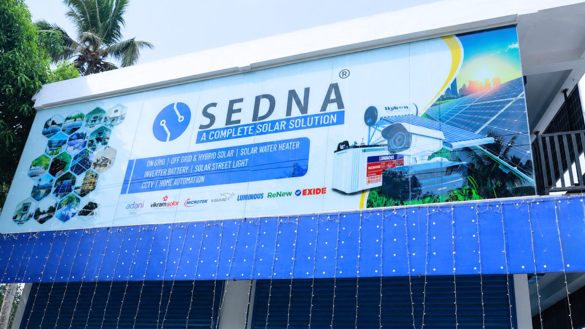 Front of the SEDNA Energy Systems office at Neyyarapally Arcade, Muttom, Cherthala, with the blue SEDNA board