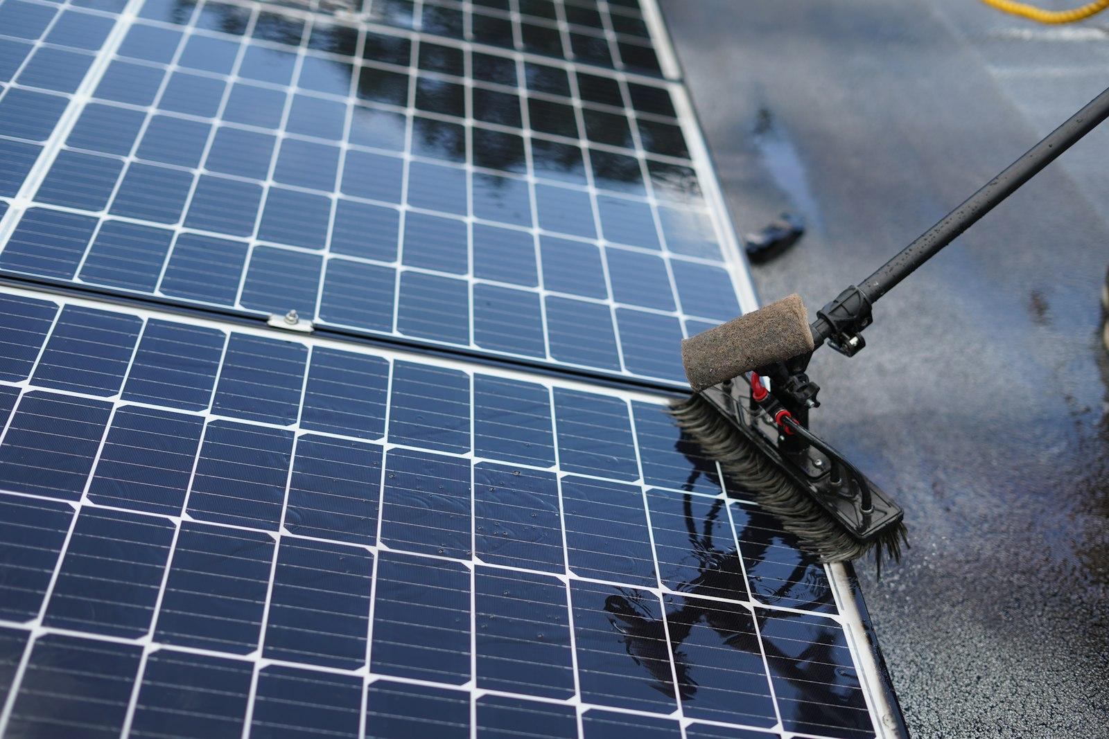 Solar panels being cleaned with a soft brush